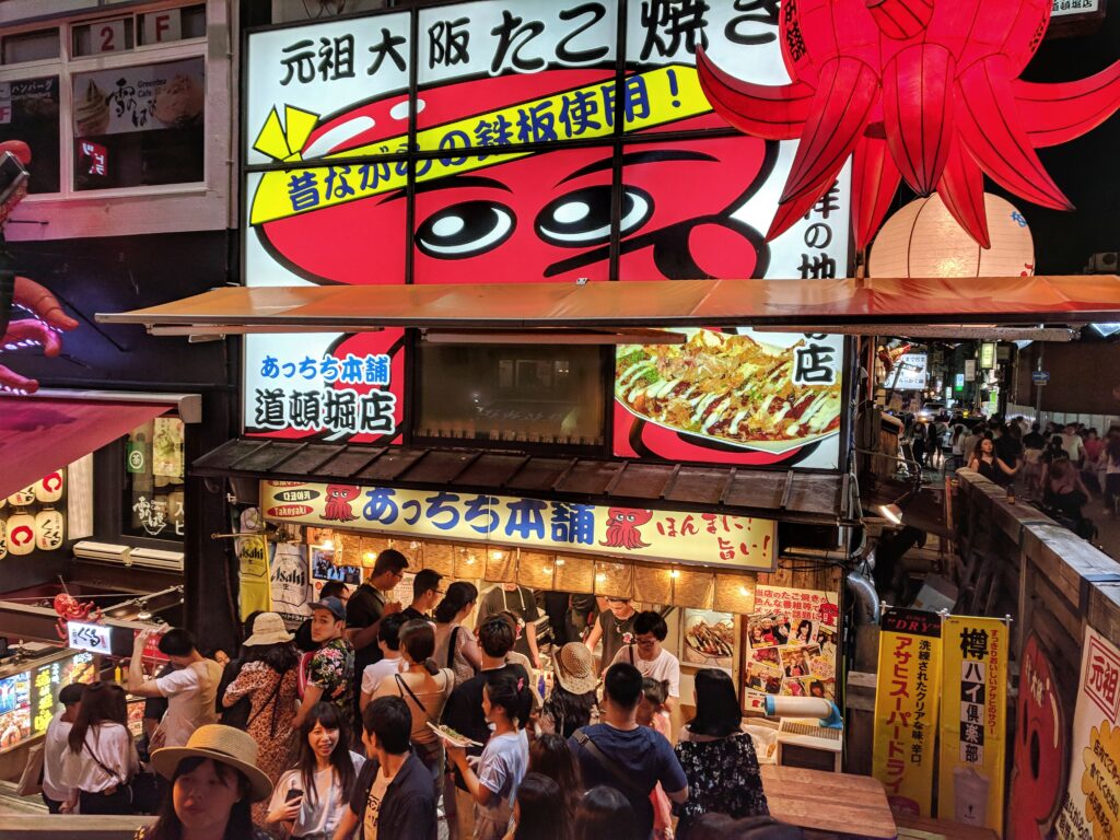 Osaka Japan (5) Achichi selling Tako in Dotonburi (by the canal), store front with a giant octopus signboard. It is located one bridge away from the Glico Running man, near Holiday Inn Namba